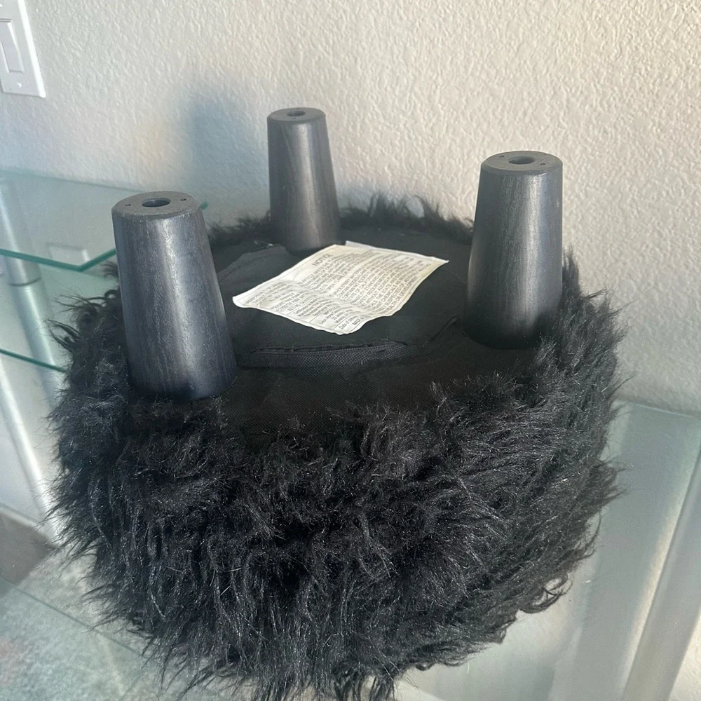 black faux fur ottoman/stool with 3 wooden legs